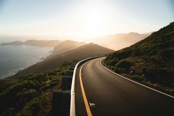 A winding coastal road through the hills near the California coast